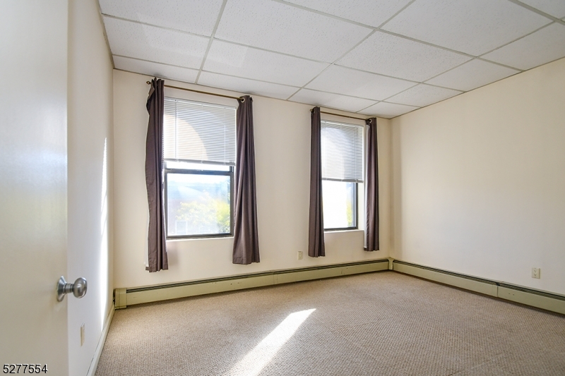 431 Springfield Avenue, Unit 6 Summit, NJ 07901 - Photo 6 of 9 an empty room with windows
