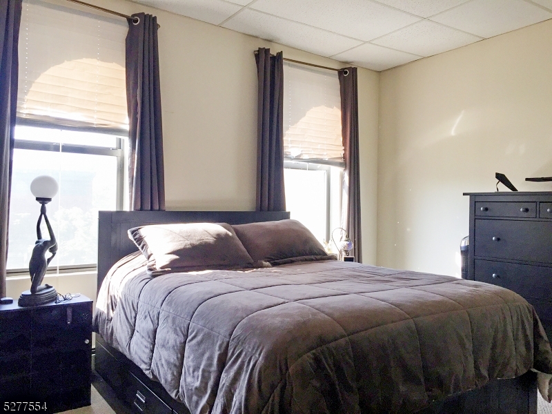 431 Springfield Avenue, Unit 6 Summit, NJ 07901 - Photo 7 of 9 a bedroom with a bed and a window