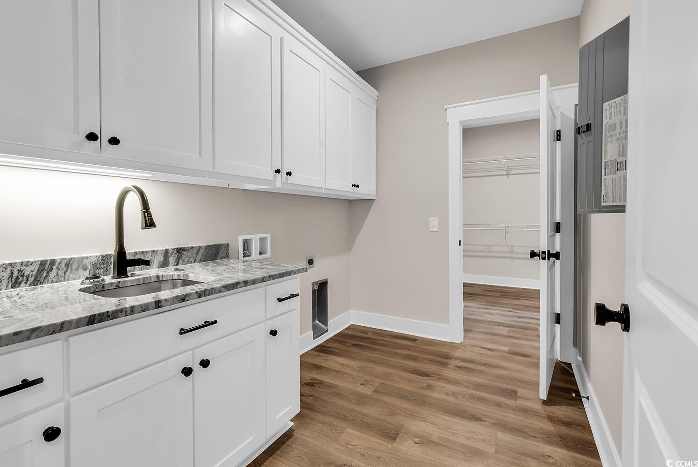 713 Horry Road Aynor, SC 29511 - Photo 23 of 40 Laundry area with light wood-style flooring, cabinet space, washer hookup, and hookup for an electric dryer