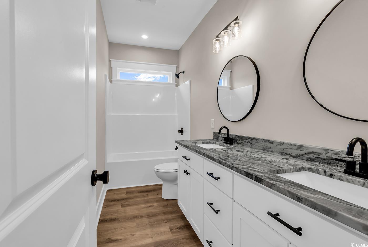 713 Horry Road Aynor, SC 29511 - Photo 27 of 40 Full bath with dark wood-type flooring, shower / washtub combination, and double vanity