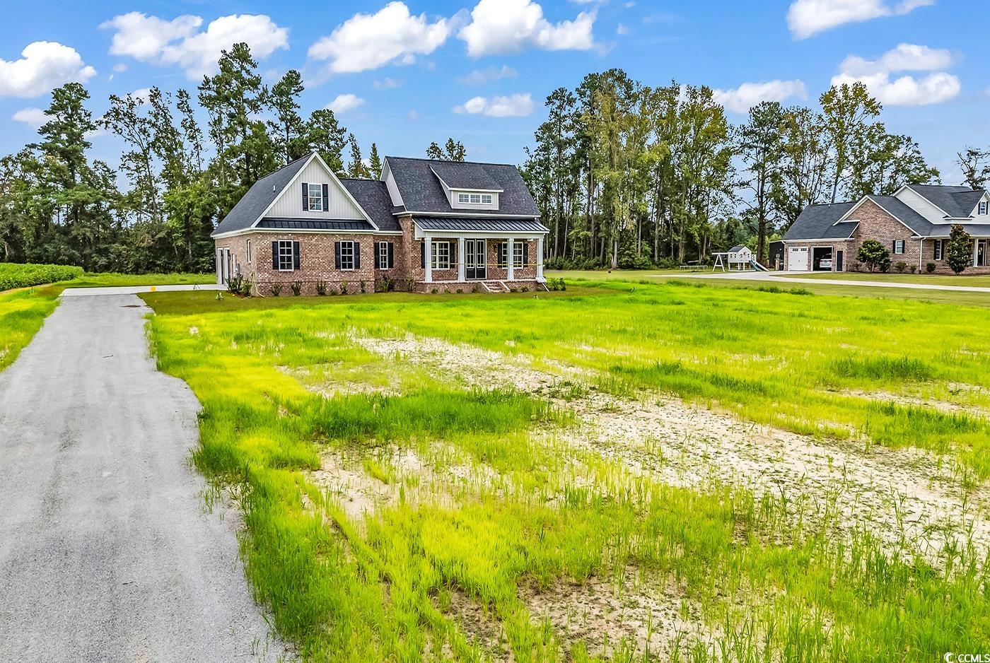 713 Horry Road Aynor, SC 29511 - Photo 40 of 40 View of front of house with a metal roof, a front lawn, a standing seam roof, and a porch