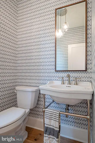 a kitchen with stainless steel appliances kitchen island granite countertop a table chairs sink and cabinets