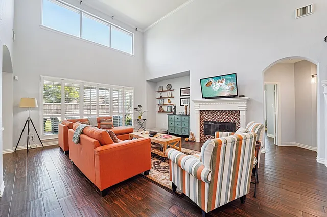 a living room with fireplace furniture and a wooden floor