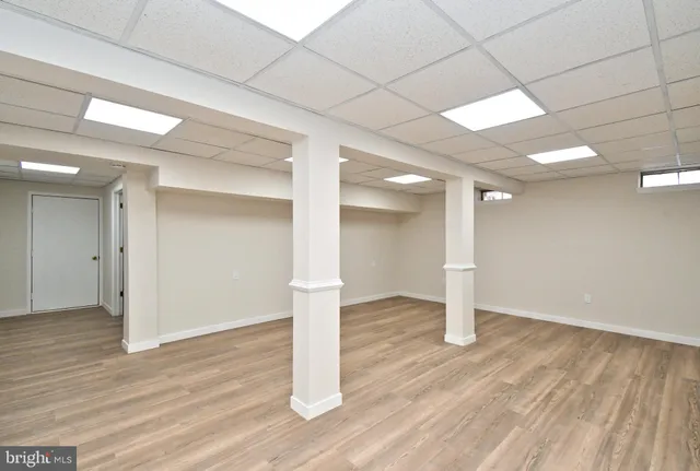 a view of a room with wooden floor