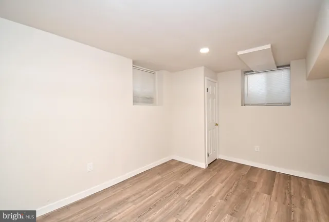 a view of a room with wooden floor and white walls