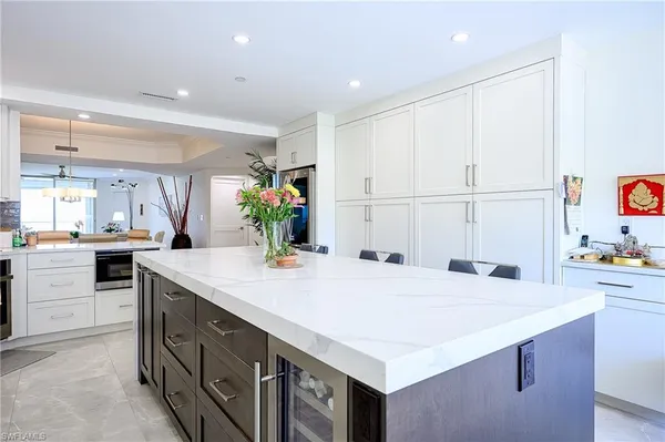a kitchen with kitchen island a sink appliances and cabinets
