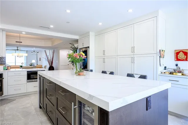 a kitchen with kitchen island a sink appliances and cabinets