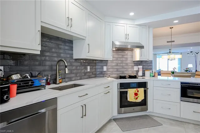 a kitchen with stainless steel appliances granite countertop a stove and a sink