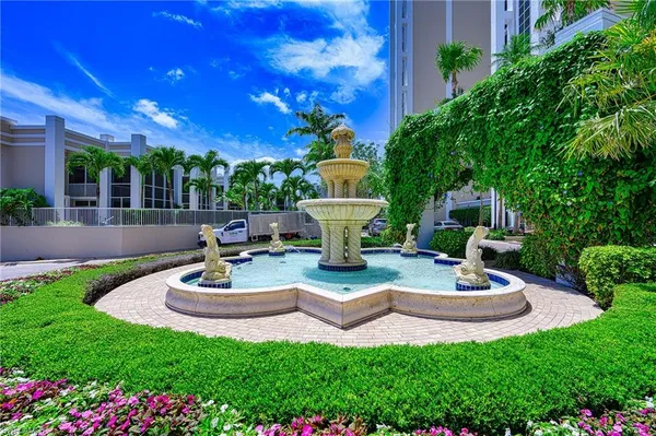 a view of a house with backyard sitting area and swimming pool
