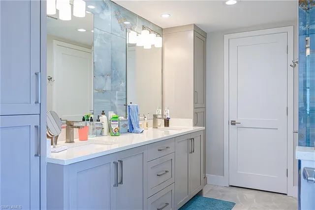 a bathroom with a double vanity sink and a mirror