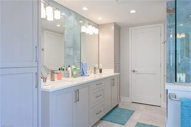 a bathroom with a double vanity sink and a mirror