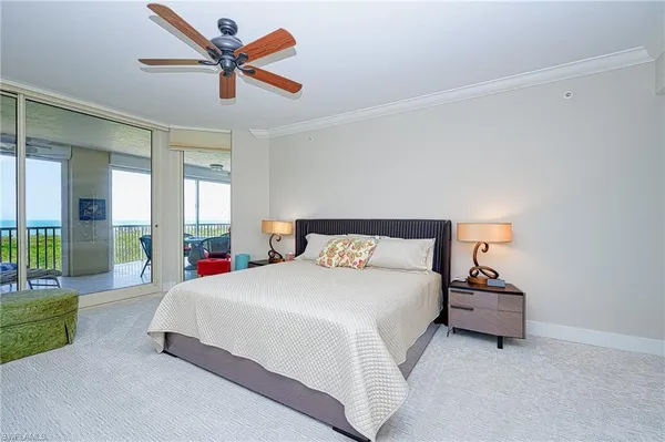 a bedroom with a bed and ceiling fan