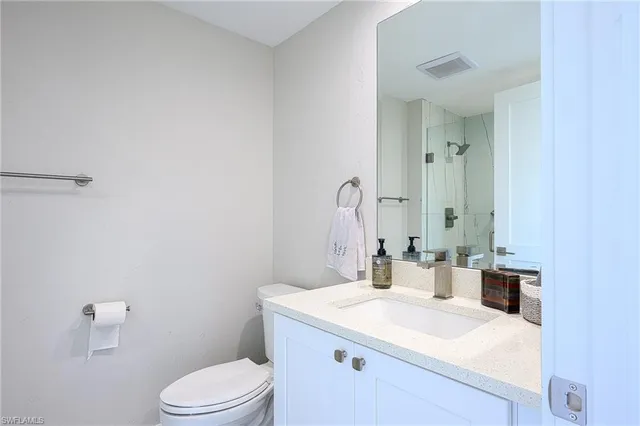 a bathroom with a sink a toilet and mirror