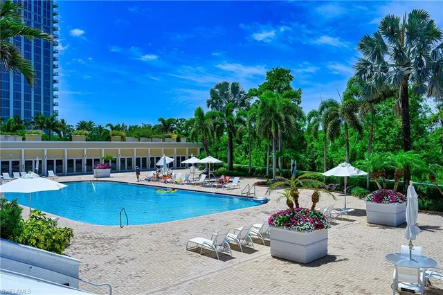 a view of a swimming pool with a patio and swimming pool