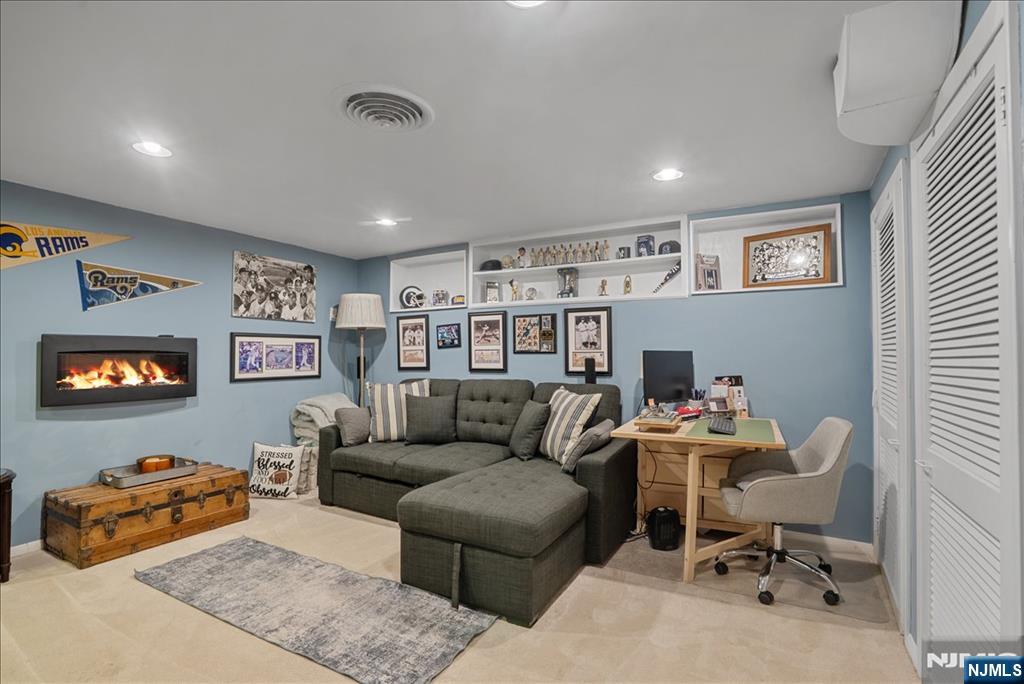 11 Westland Road Verona, NJ 07044 - Photo 22 of 29 a living room with furniture and a bookshelf