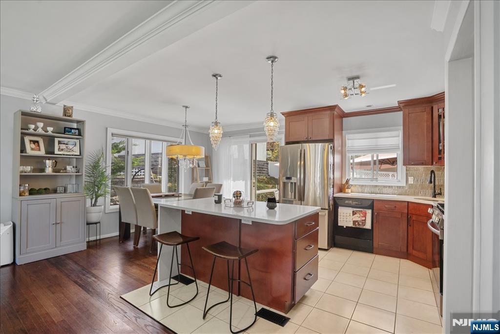 11 Westland Road Verona, NJ 07044 - Photo 3 of 29 a dining hall with stainless steel appliances kitchen island granite countertop wooden floor a dining table and chairs