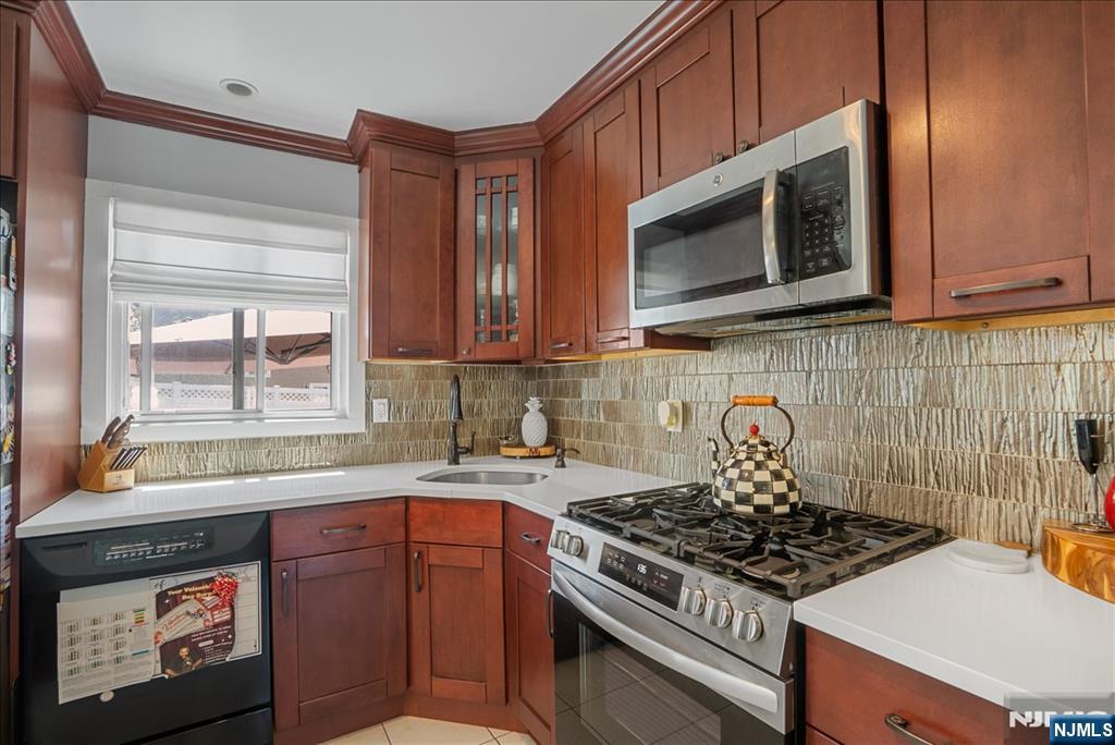 11 Westland Road Verona, NJ 07044 - Photo 7 of 29 a kitchen with stainless steel appliances a stove a microwave cabinets and a sink