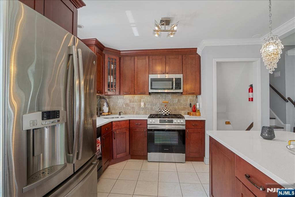 11 Westland Road Verona, NJ 07044 - Photo 8 of 29 a kitchen with stainless steel appliances granite countertop a refrigerator stove and sink