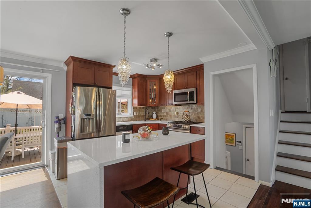 11 Westland Road Verona, NJ 07044 - Photo 10 of 29 a open kitchen with stainless steel appliances granite countertop a refrigerator a sink dishwasher a stove and a dining table with wooden floor