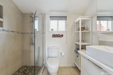 a bathroom with a sink toilet and shower