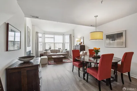 a view of a dining room with furniture window and wooden floor