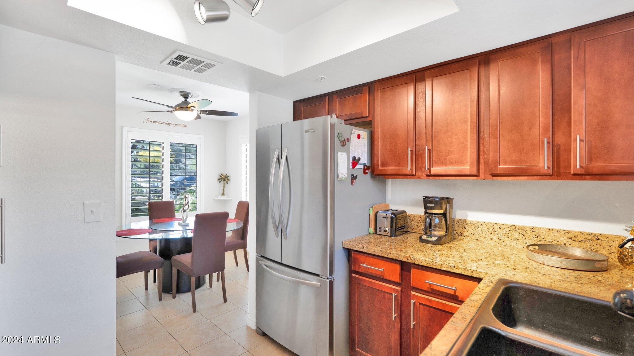 9990 North Scottsdale Road, Unit 1019 Paradise Valley, AZ 85253 - Photo 9 of 30 a kitchen with stainless steel appliances granite countertop a refrigerator and a sink