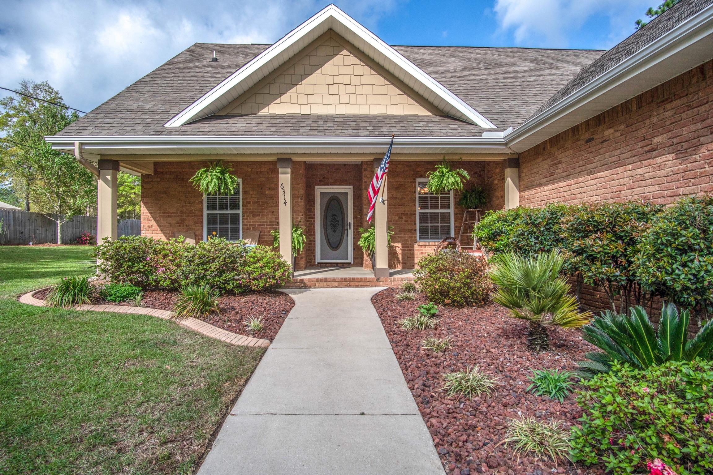 6314 Possum Ridge Road Crestview, FL 32539 - Photo 1 of 47 a front view of a house with garden