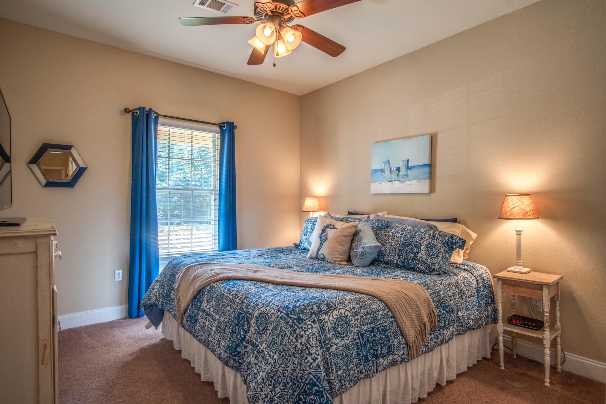 6314 Possum Ridge Road Crestview, FL 32539 - Photo 15 of 47 a bedroom with a large bed and a chandelier