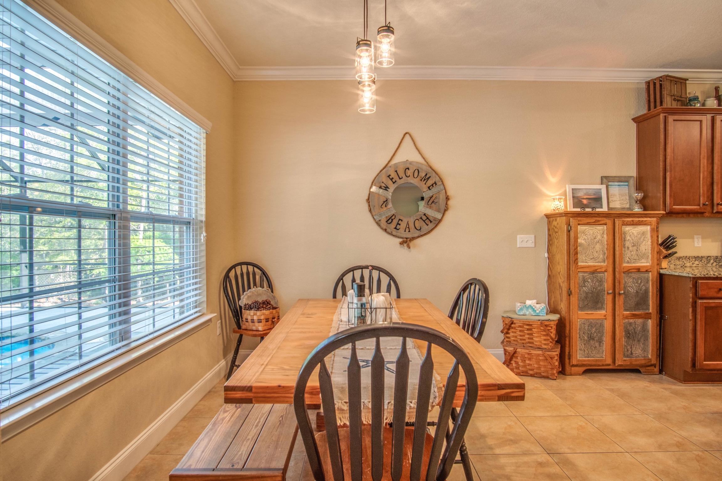 6314 Possum Ridge Road Crestview, FL 32539 - Photo 17 of 47 a view of a hallway with a dining table & chairs
