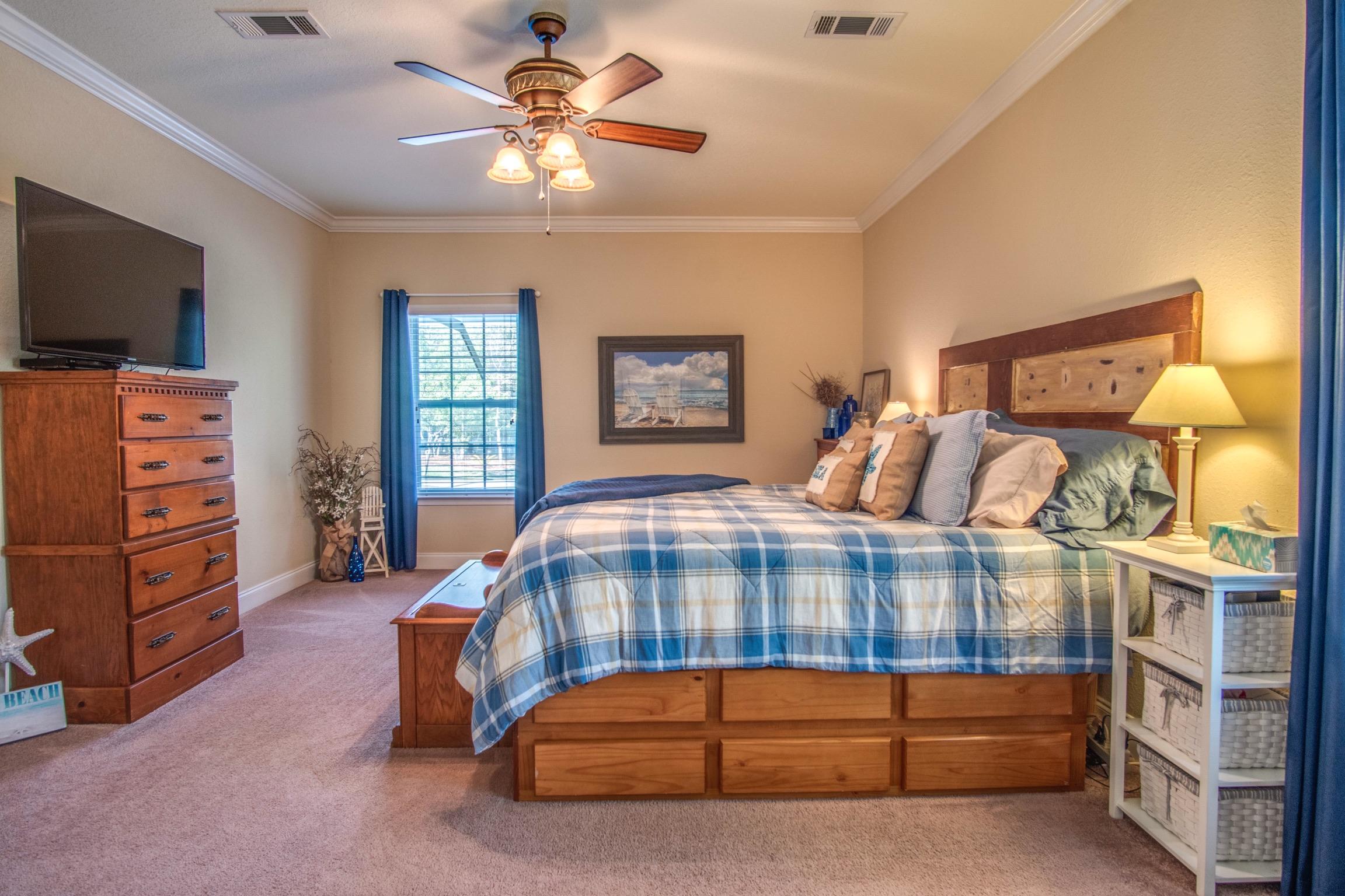 6314 Possum Ridge Road Crestview, FL 32539 - Photo 23 of 47 a bedroom with a bed and a flat tv screen on dresser
