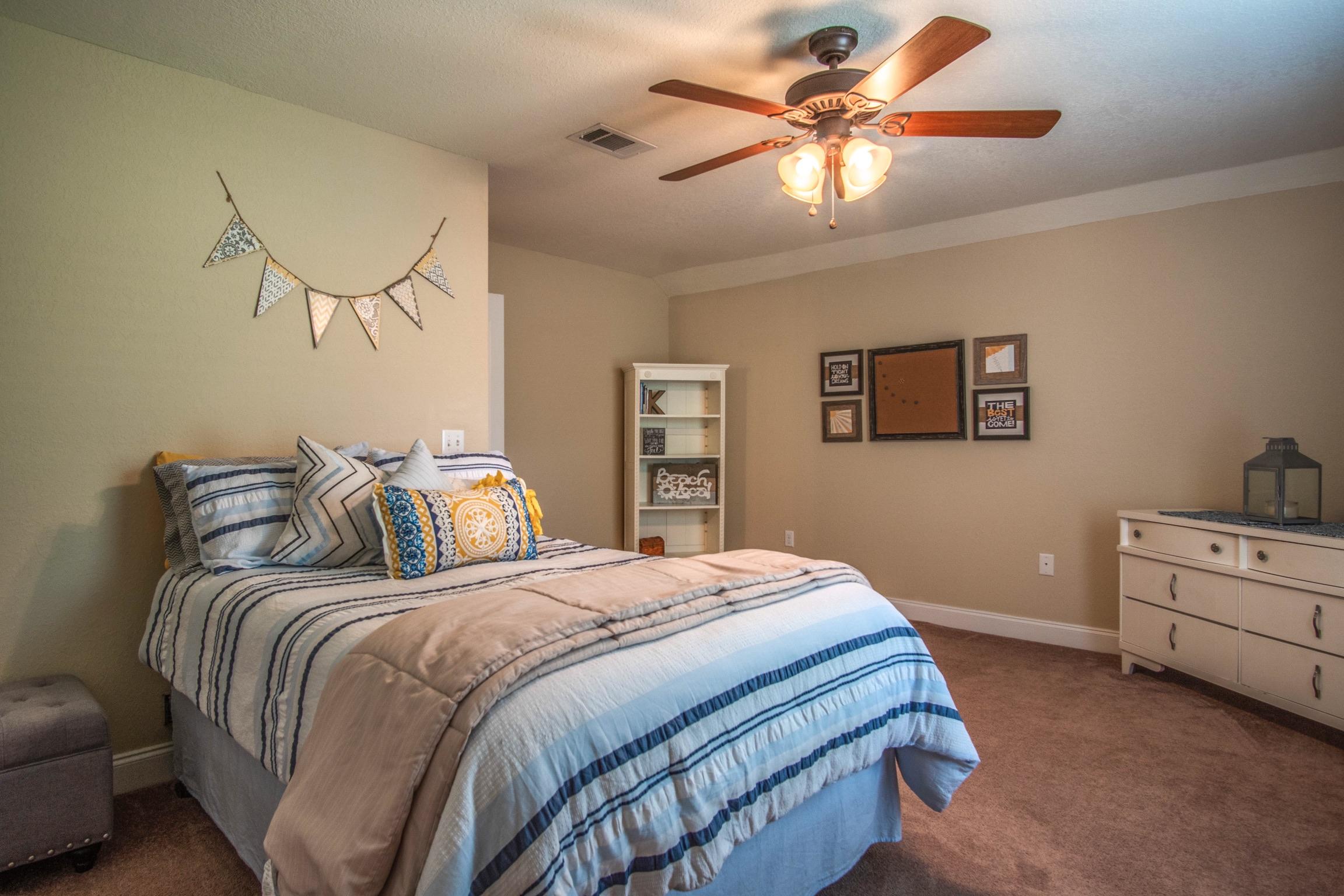 6314 Possum Ridge Road Crestview, FL 32539 - Photo 30 of 47 a bedroom with a bed and a chandelier