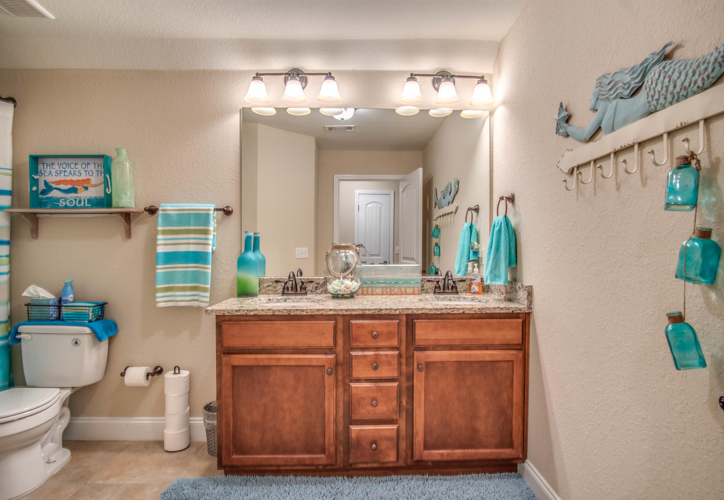 6314 Possum Ridge Road Crestview, FL 32539 - Photo 31 of 47 a bathroom with a granite countertop sink a toilet and a mirror
