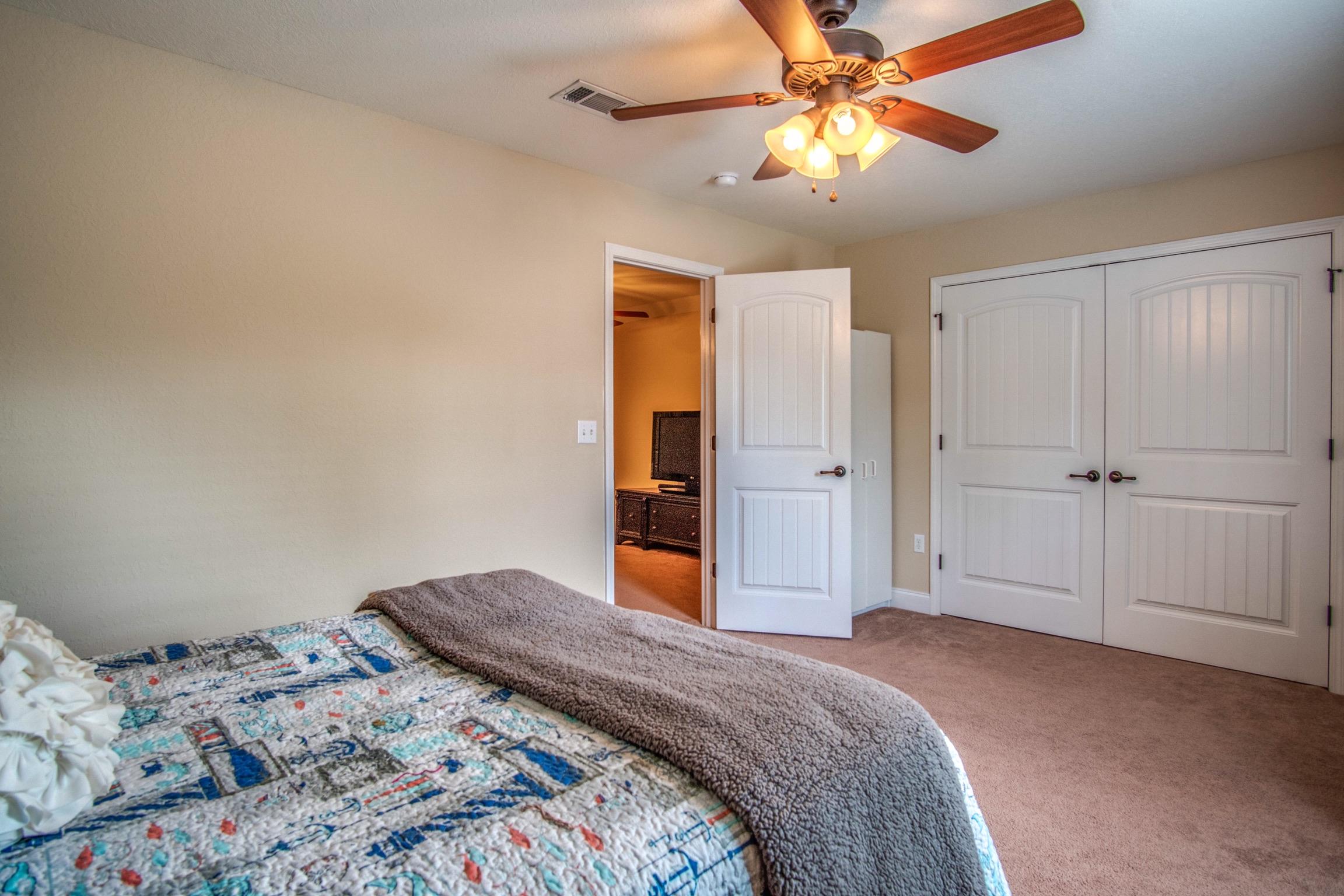 6314 Possum Ridge Road Crestview, FL 32539 - Photo 36 of 47 a bedroom with a bed and a chandelier