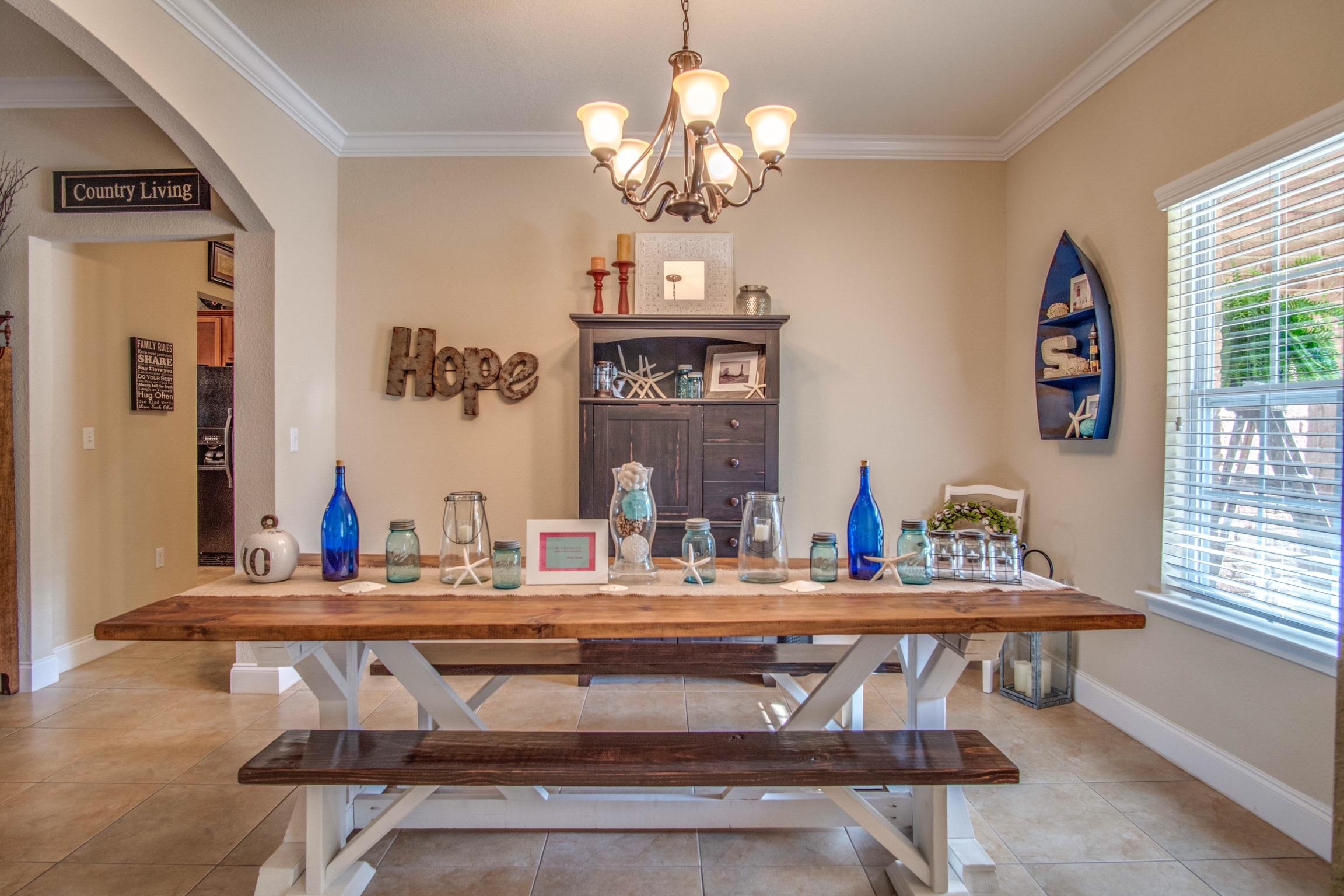 6314 Possum Ridge Road Crestview, FL 32539 - Photo 5 of 47 a kitchen with a table and a chandelier