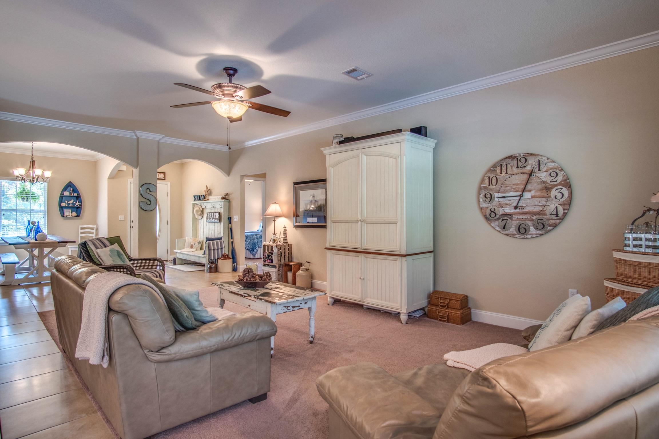 6314 Possum Ridge Road Crestview, FL 32539 - Photo 8 of 47 a living room with furniture and a chandelier