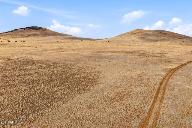 a view of a large mountain with mountains in the background