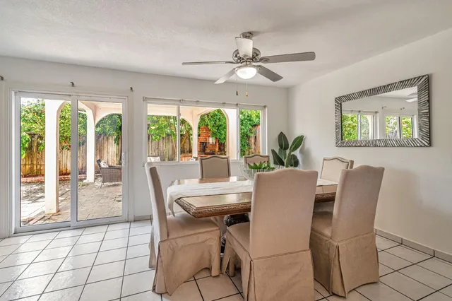 a dining room with furniture a chandelier and wooden floor