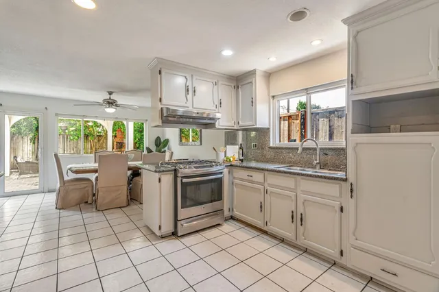 a kitchen with appliances cabinets and furniture