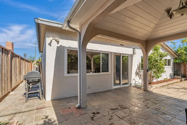 a view of a porch with chairs and floor to ceiling window