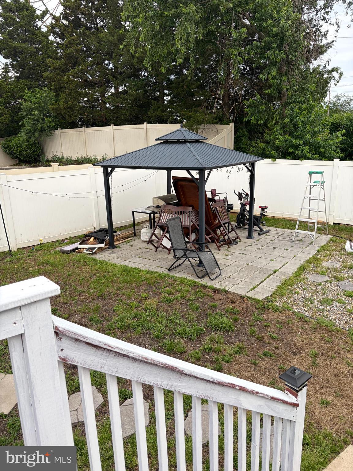 7404 Wyndam Road Pennsauken, NJ 08110 - Photo 44 of 50 a view of a backyard with table and chairs under an umbrella
