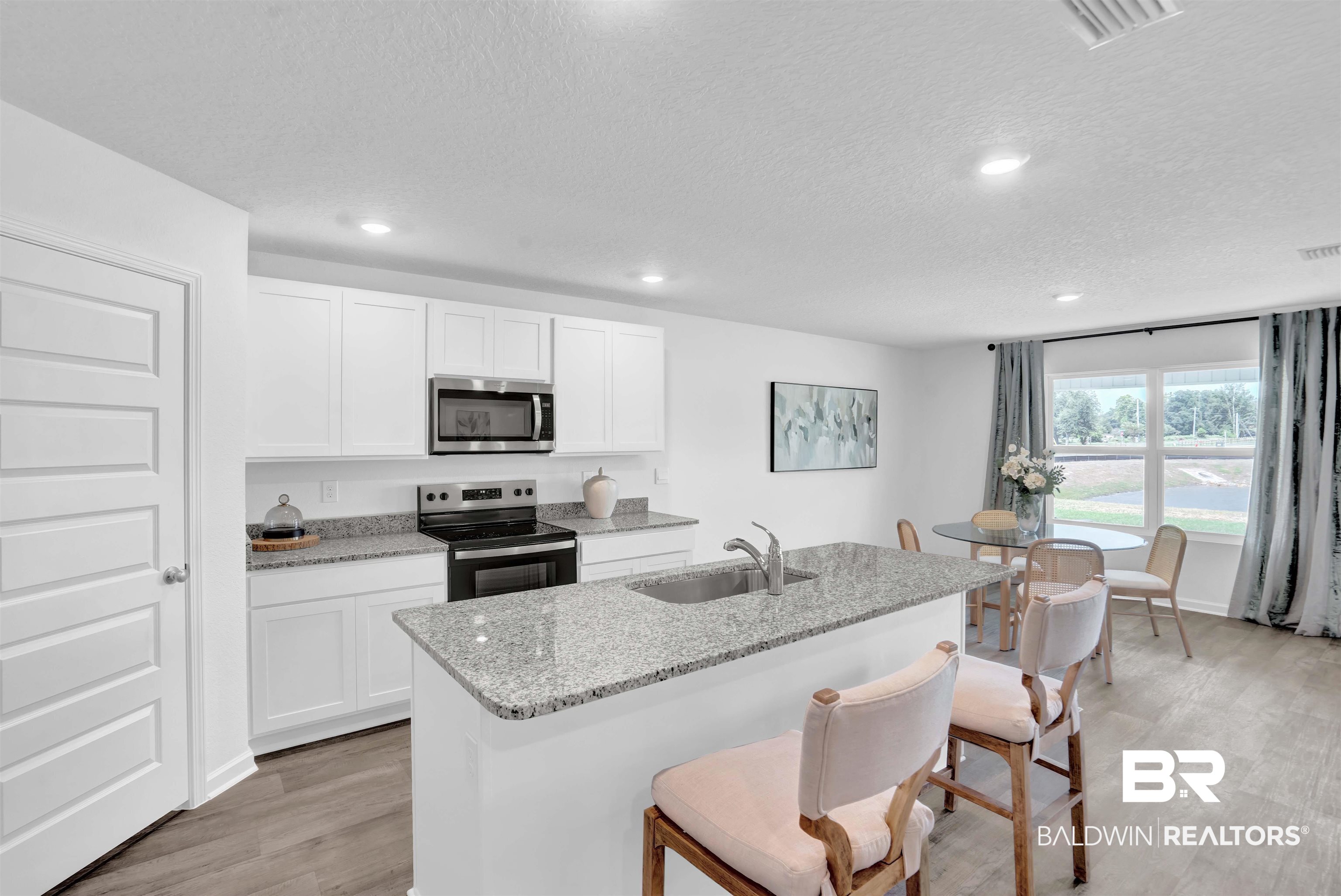 14717 Dayton Circle Foley, AL 36535 - Photo 15 of 39 Kitchen with white cabinetry, sink, light hardwood / wood-style floors, and appliances with stainless steel finishes