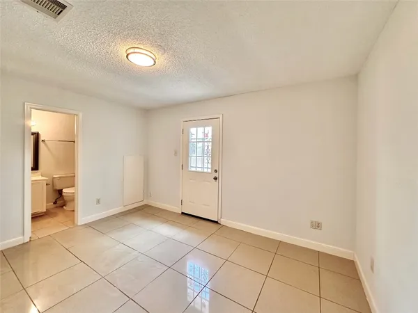 a view of an empty room and a window