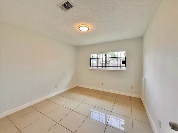 a view of a livingroom with wooden floor and a fan