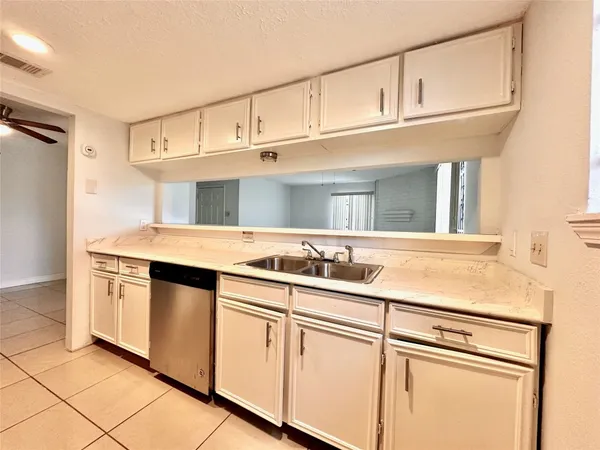 a kitchen with cabinets stainless steel appliances and a sink