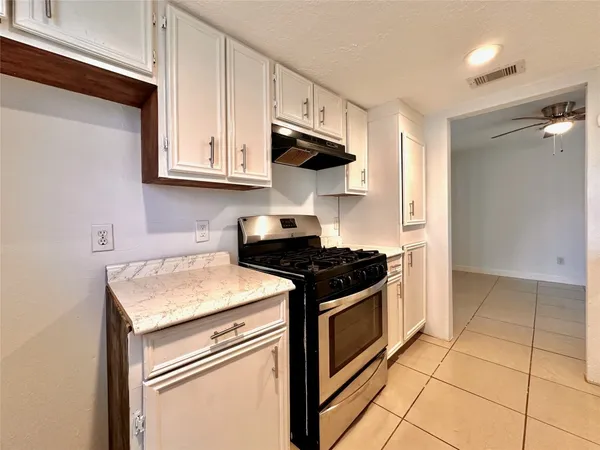 a kitchen with stainless steel appliances granite countertop a stove and a sink