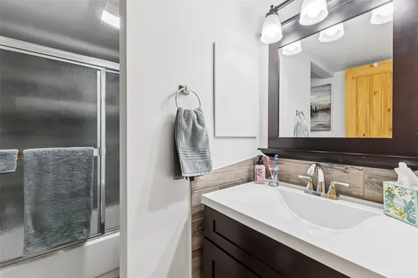 a bathroom with a sink and a mirror