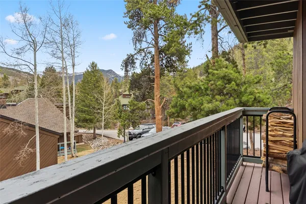 a view of balcony with wooden floor and fence