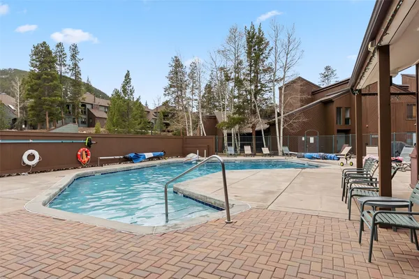 a swimming pool with outdoor seating