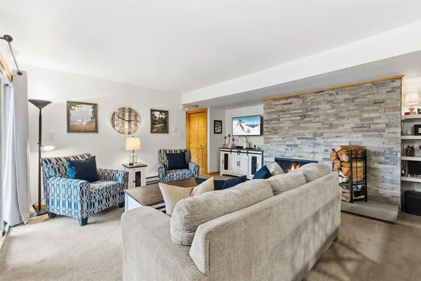 a living room with couches and a flat screen tv