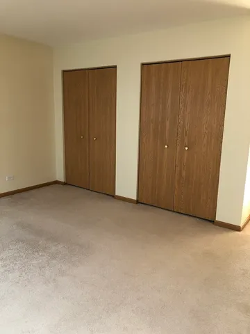 a view of an empty room with closet area